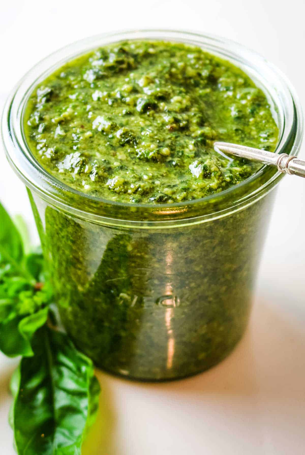 jar with pesto with spoon sticking out