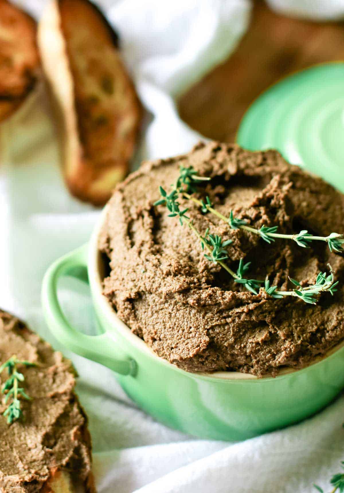 close up of beef liver pate in green ramekin