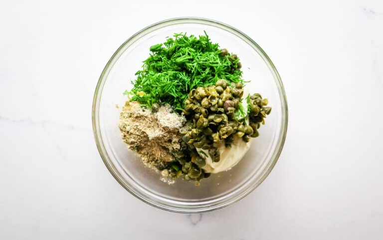bowl with mayonnaise, mashed capers, and fresh dill