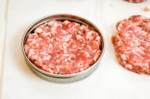 shaping sausage patties into a round mason jar ring