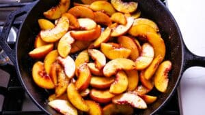sliced peaches in cast iron skillet