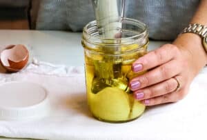 emulsifying oil and eggs with immersion blender.