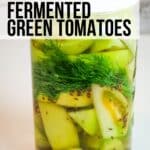 Fermented Green Tomatoes in a jar with text overlay.