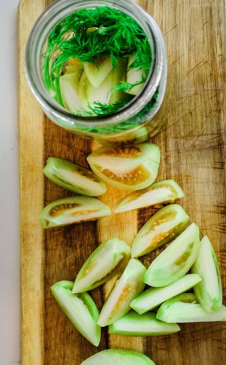 Cutting green tomatoes into wedges.
