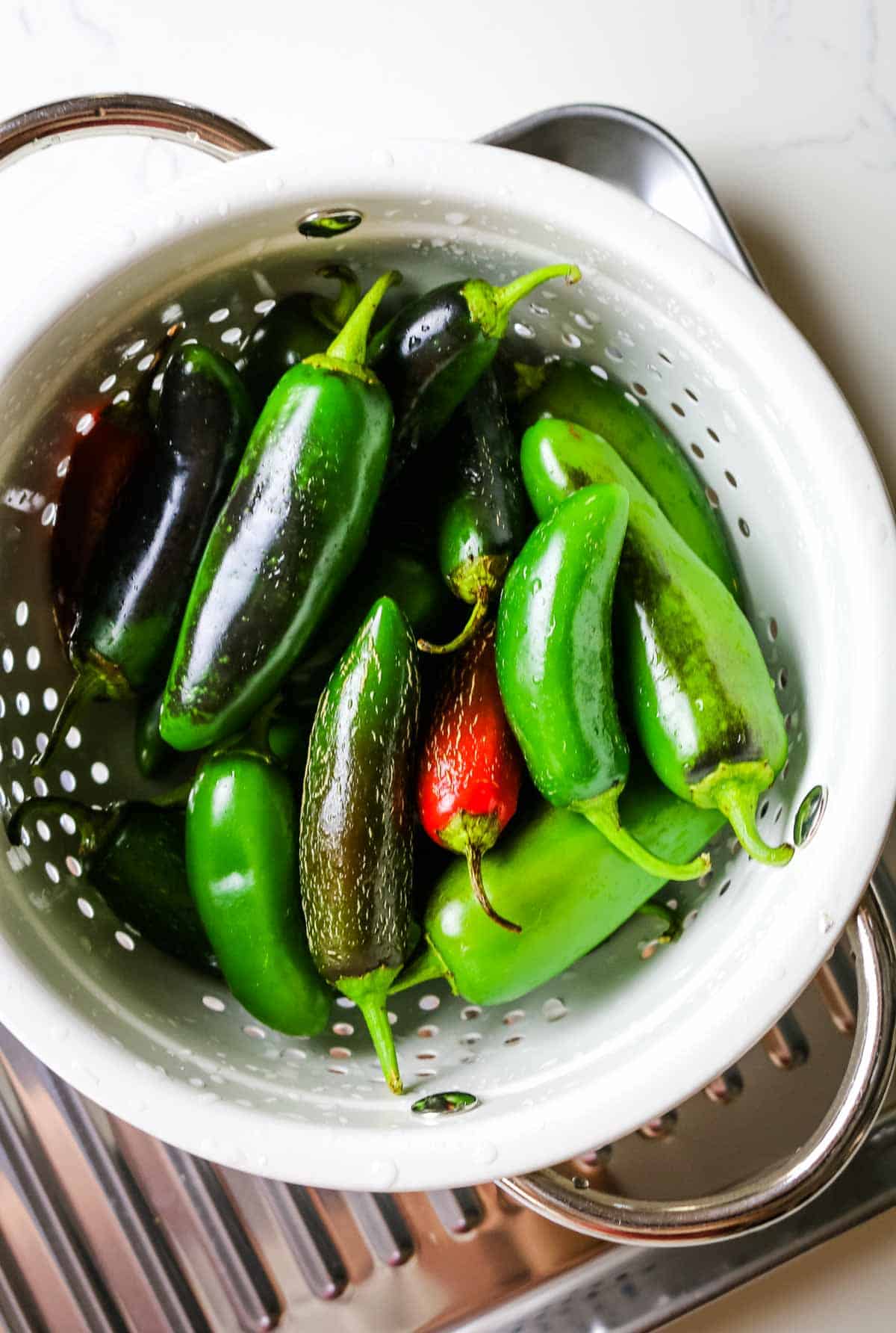jalapeno peppers in a white colander