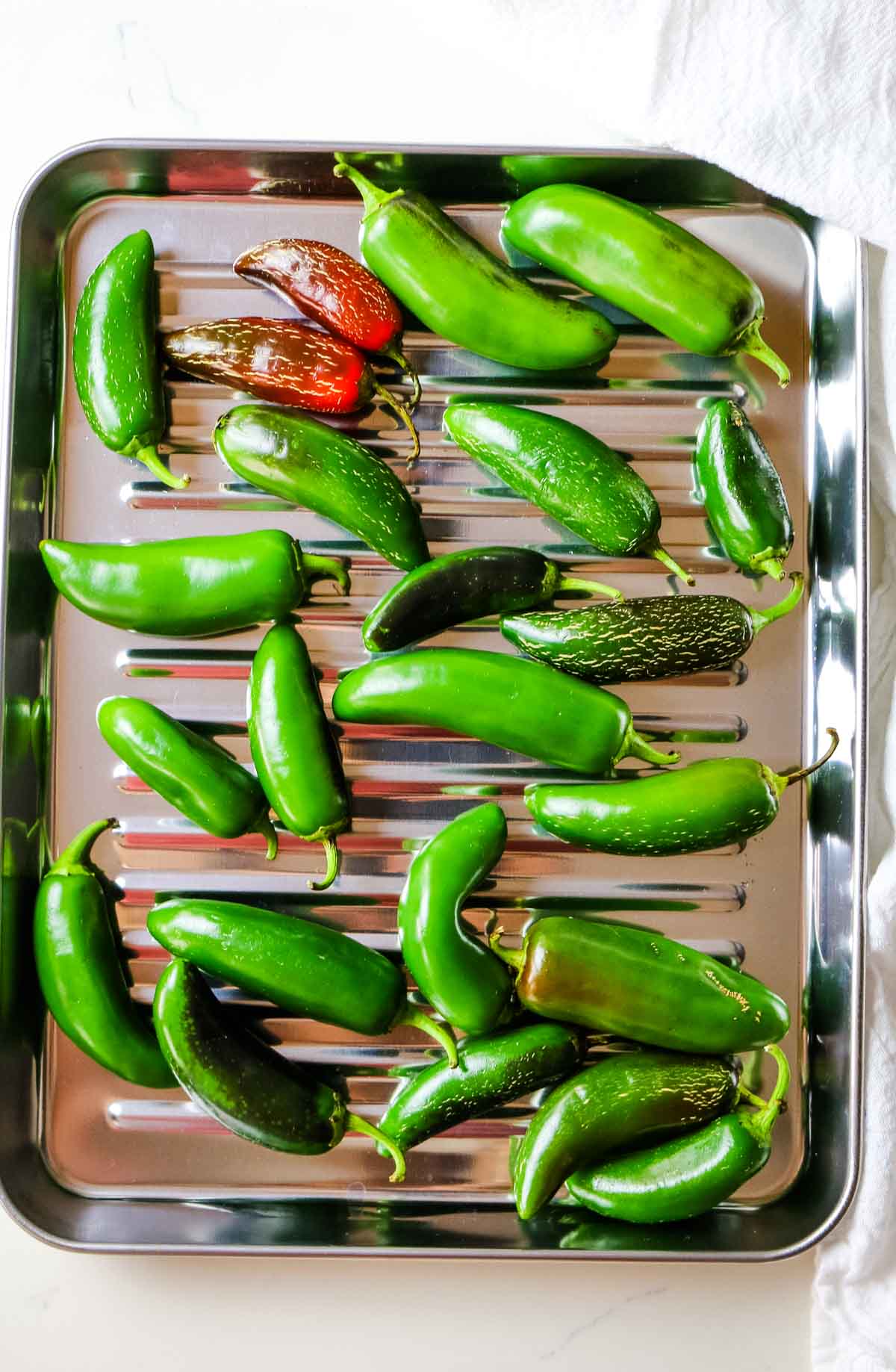jalapeno peppers on a sheet pan tray