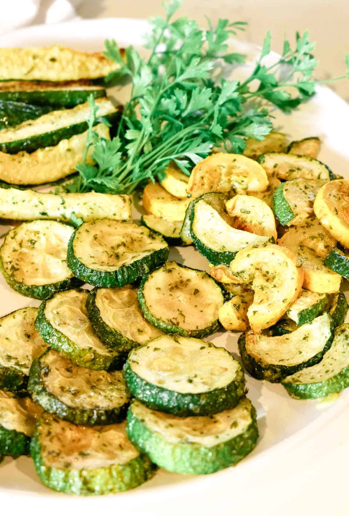 roasted zucchini rounds on white plate.