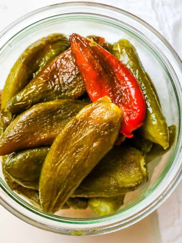 roasted and peeled peppers in a jar.
