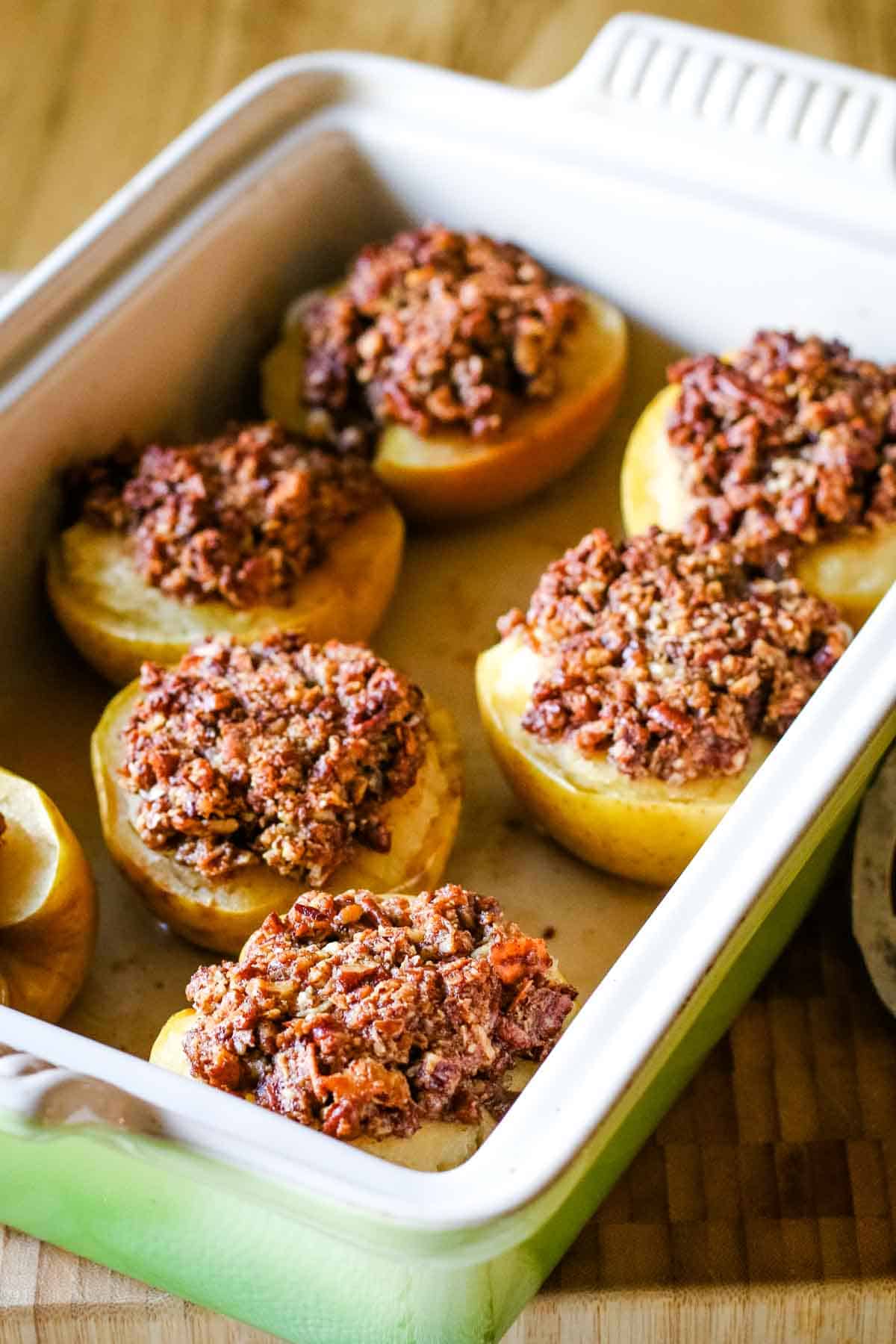 stuffed baked apples in a baking dish.