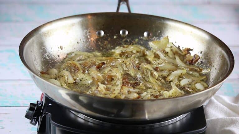 caramelized onions with seasonings in stainless steel.
