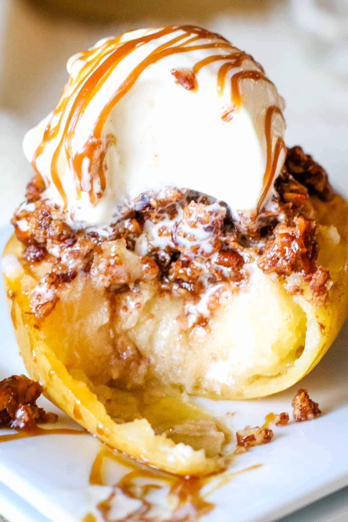 baked apple with ice cream and caramel drizzle.