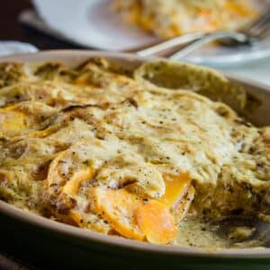 Butternut squash in creamy sauce in dish.