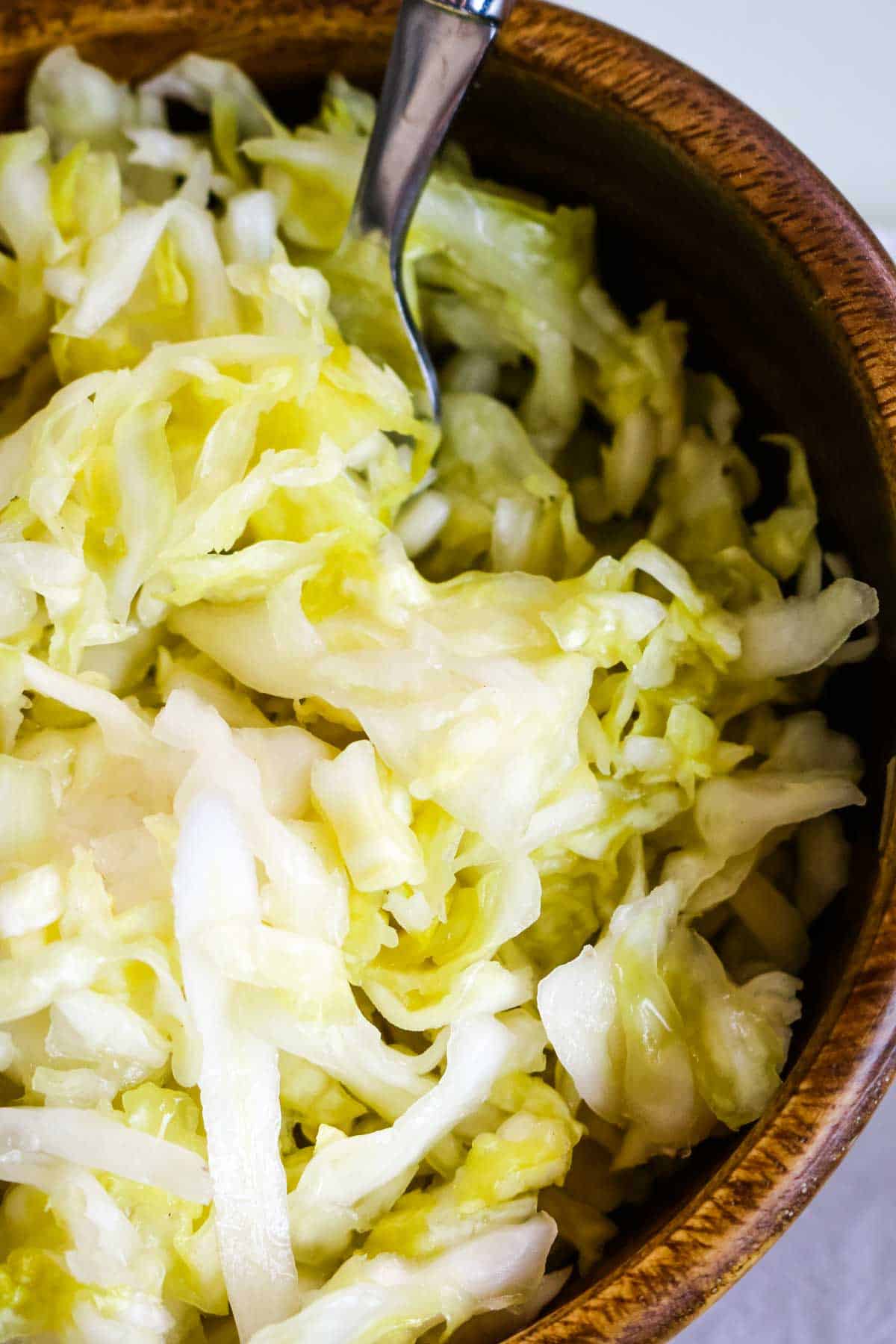sauerkraut up close in wooden bowl.
