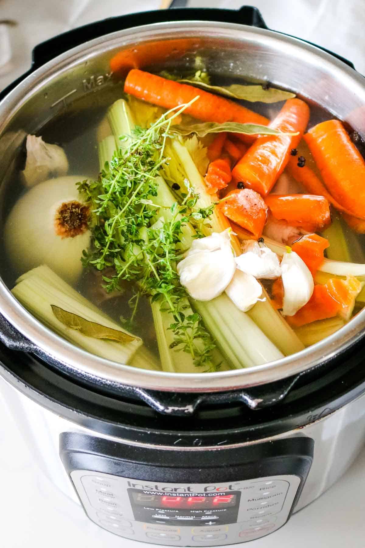 chicken and vegetables in water in instant pot.