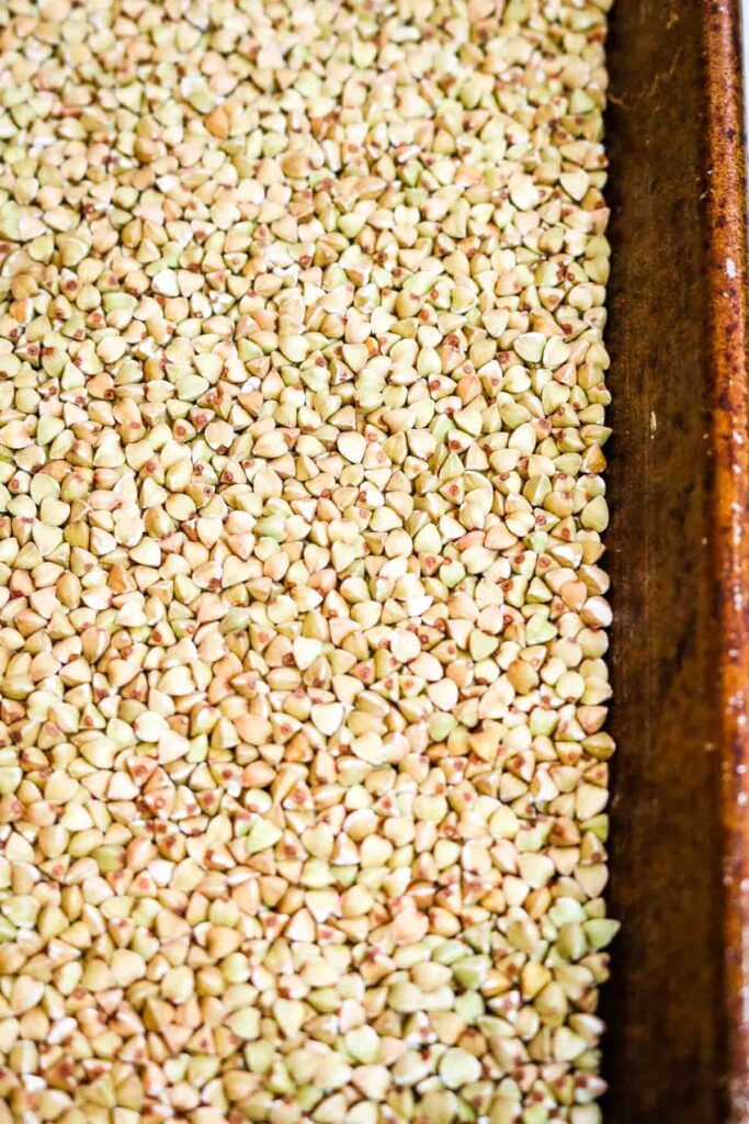 buckwheat groats in a baking sheet.