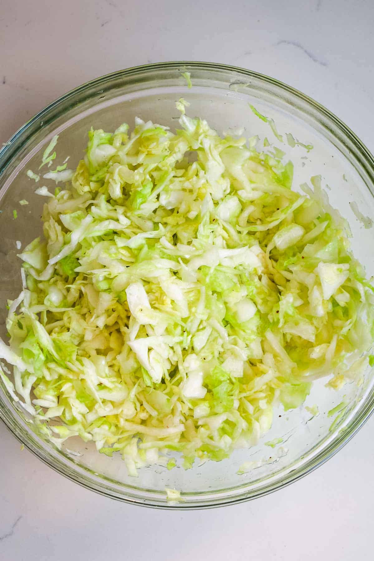 cabbage with salt in bowl.