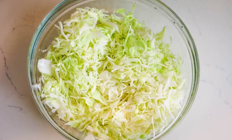 shredded cabbage in clear bowl.