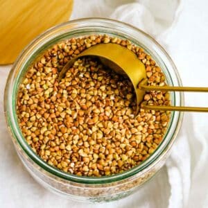 roasted buckwheat kasha in glass container.