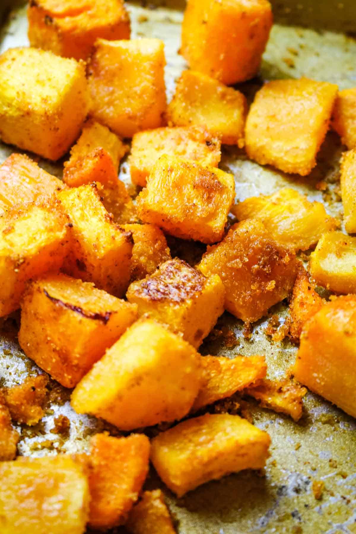 roasted butternut squash cubes on sheet.