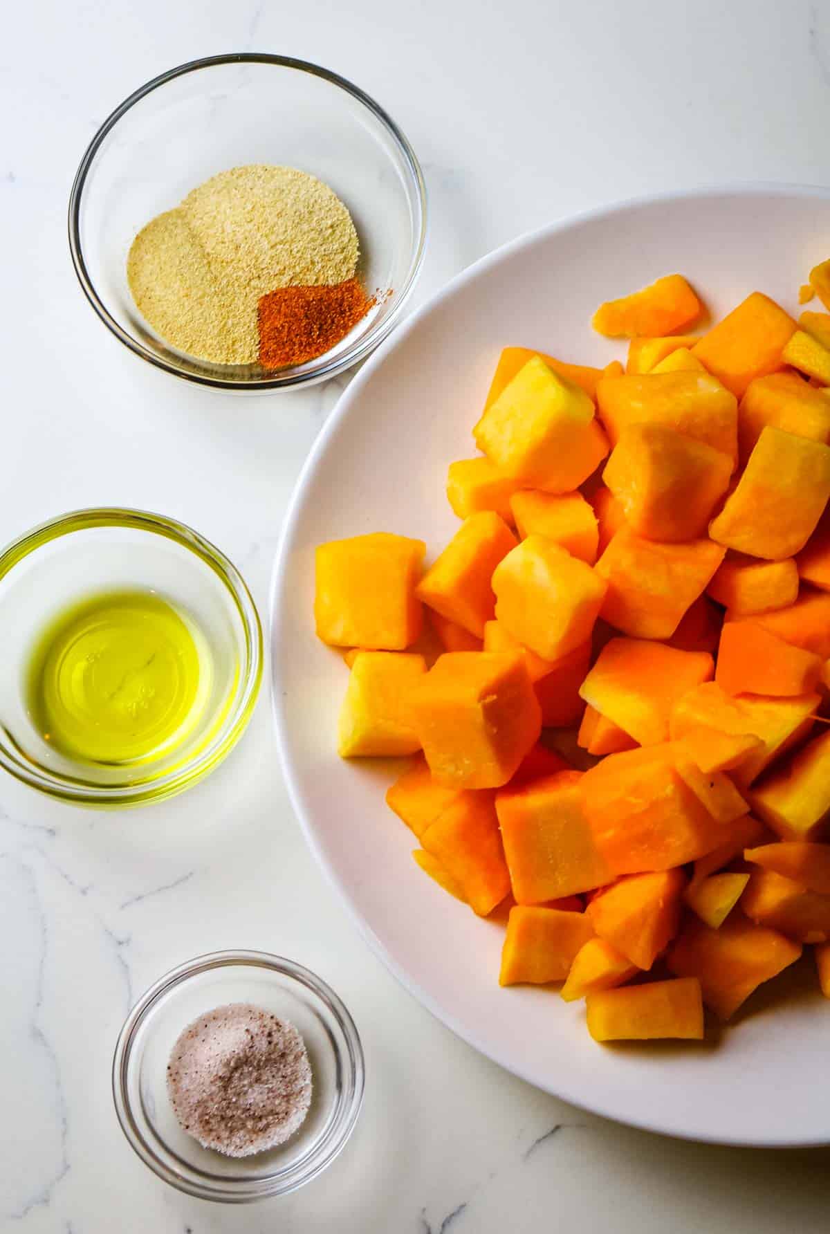 butternut squash with oil and seasonings on the side.
