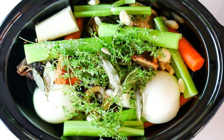 veggies on top of bones in slow cooker.