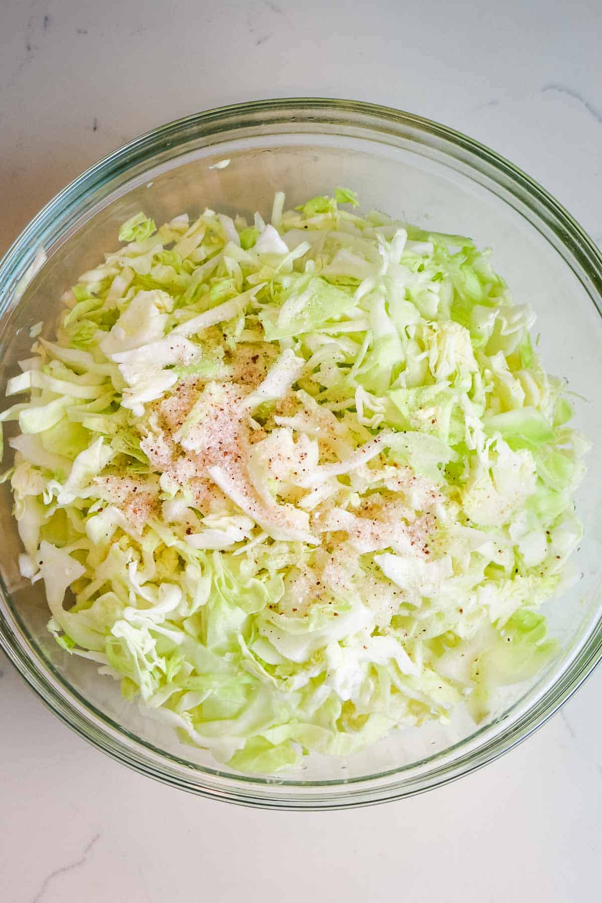cabbage with salt in glass bowl.