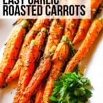 roasted carrots with parsley and garlic on white platter