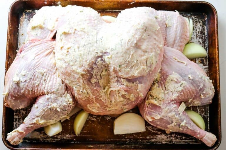 buttered turkey on baking sheet.