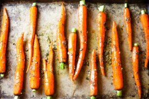 seasoned carrots on baking sheet.