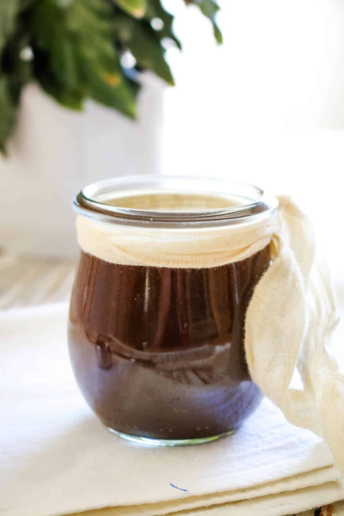 dark sauce in small jar with white ribbon
