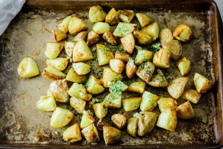 roasted potatoes on sheet pan with parsley and garlic.