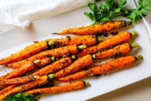 carrots garlic on white platter.