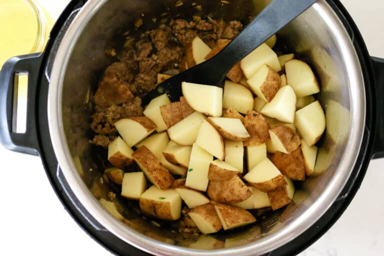 adding potatoes to instant pot.