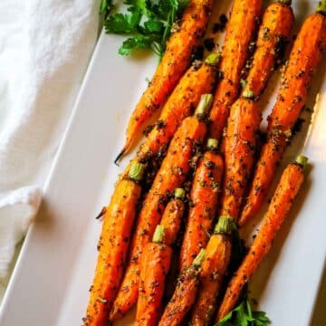 roasted carrots on white platter.