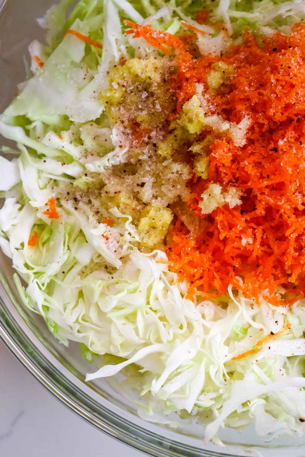 carrot, ginger, and garlic added to cabbage.