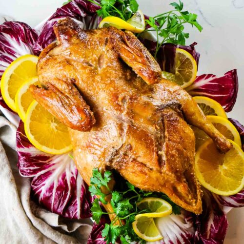 Air Fryer Duck on platter with radicchio and oranges.