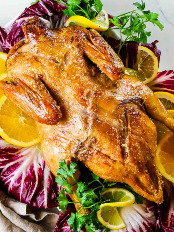 Air Fryer Duck on platter with radicchio and oranges.