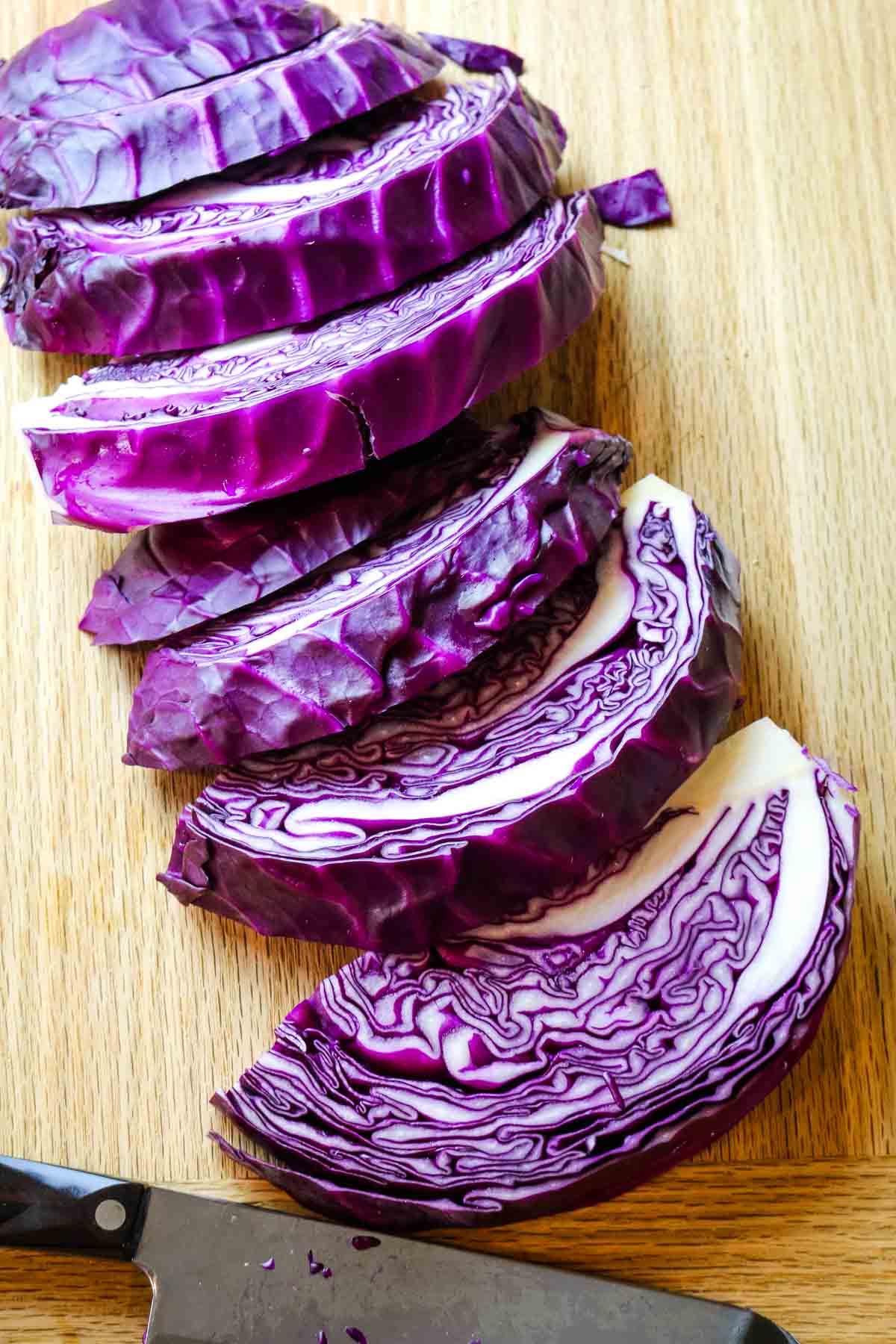 red cabbage wedges cut on board.