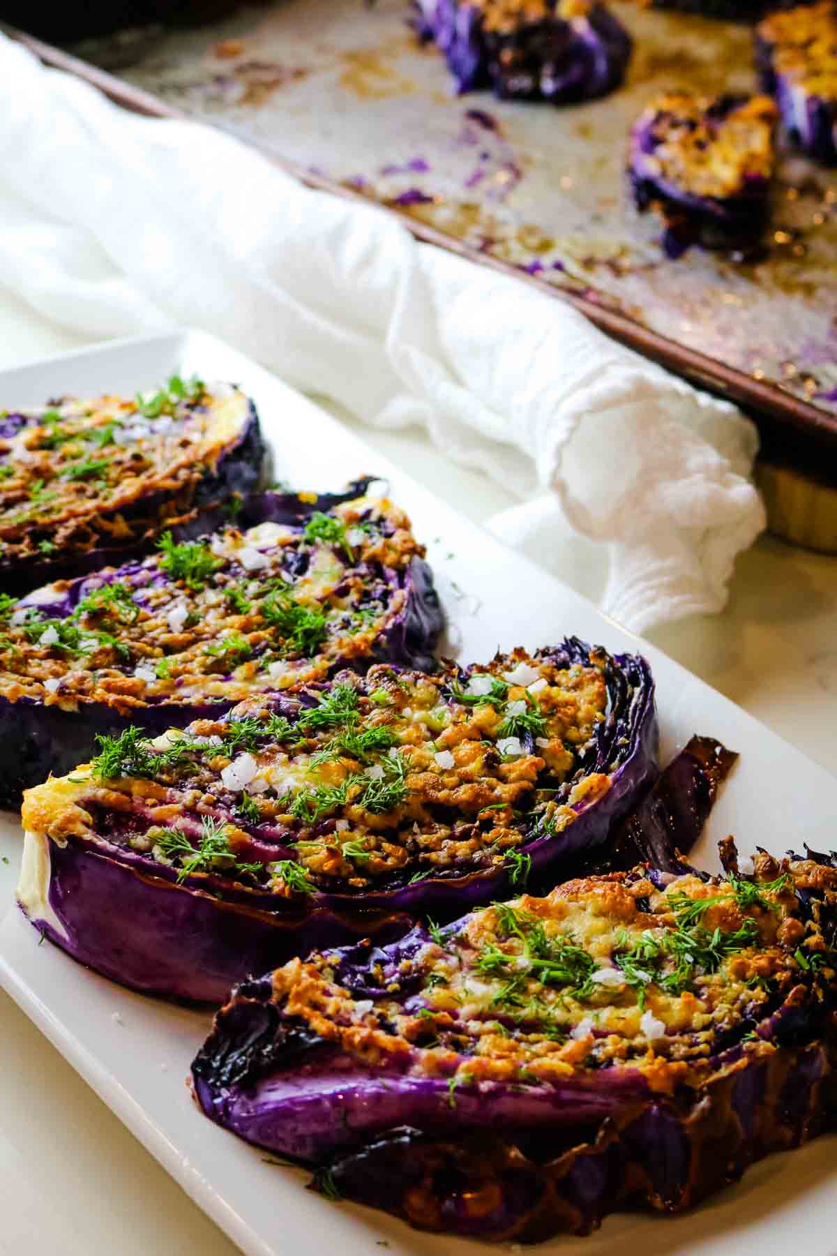 red cabbage steaks on white platter.