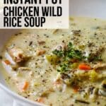 creamy chicken wild rice soup in white bowl with text overlay.