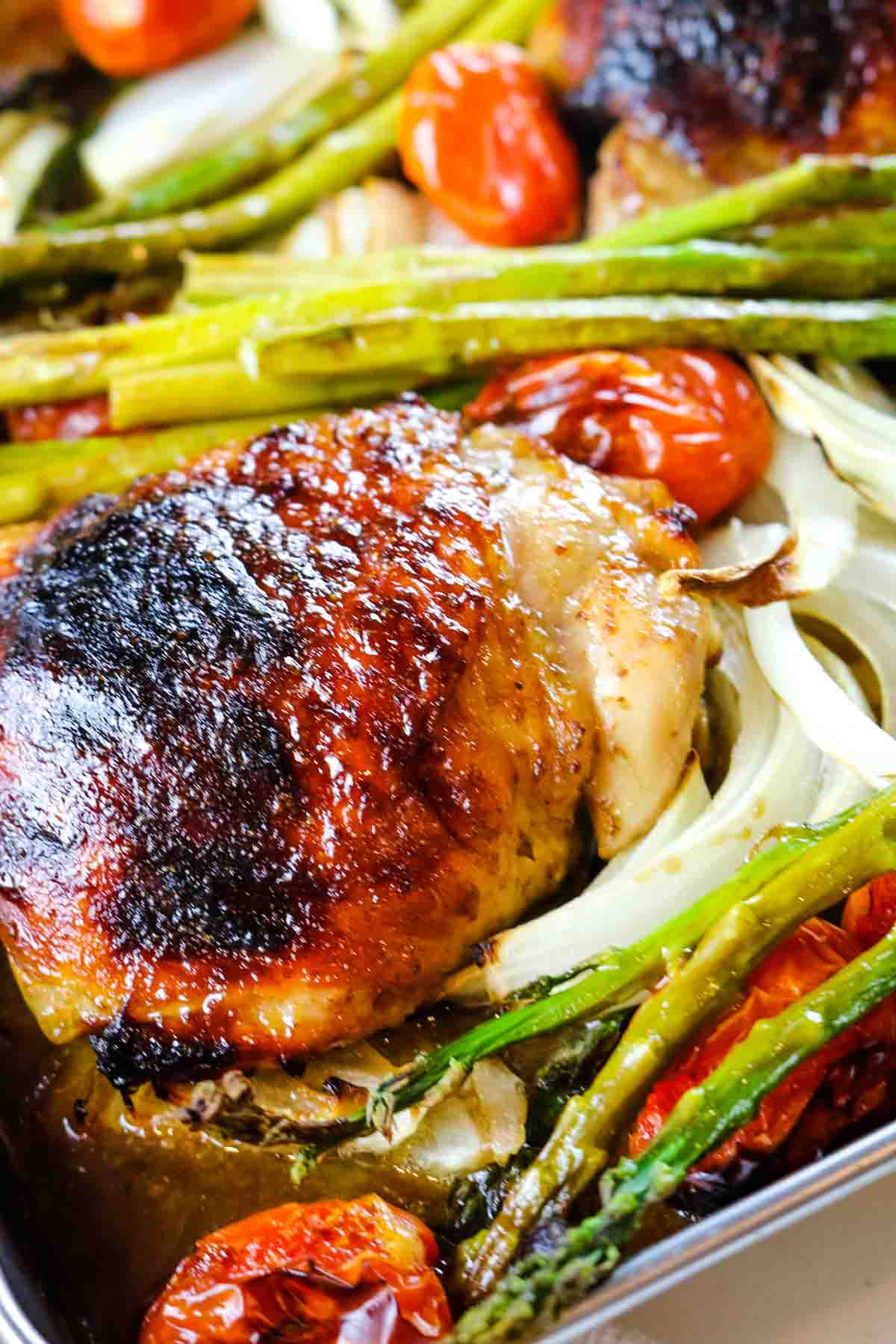 close up of balsamic chicken with asparagus and onions.