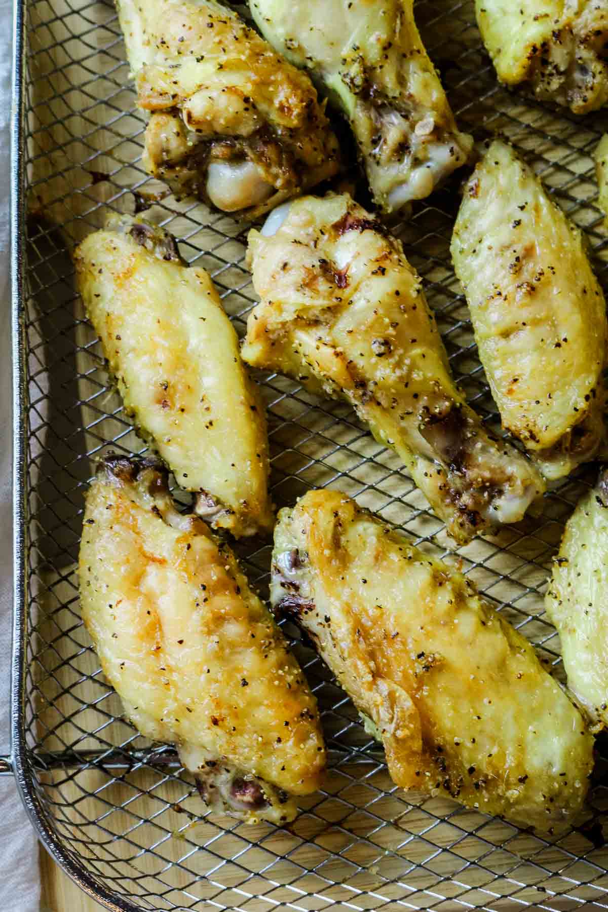 chicken wings spread out on crisper tray.