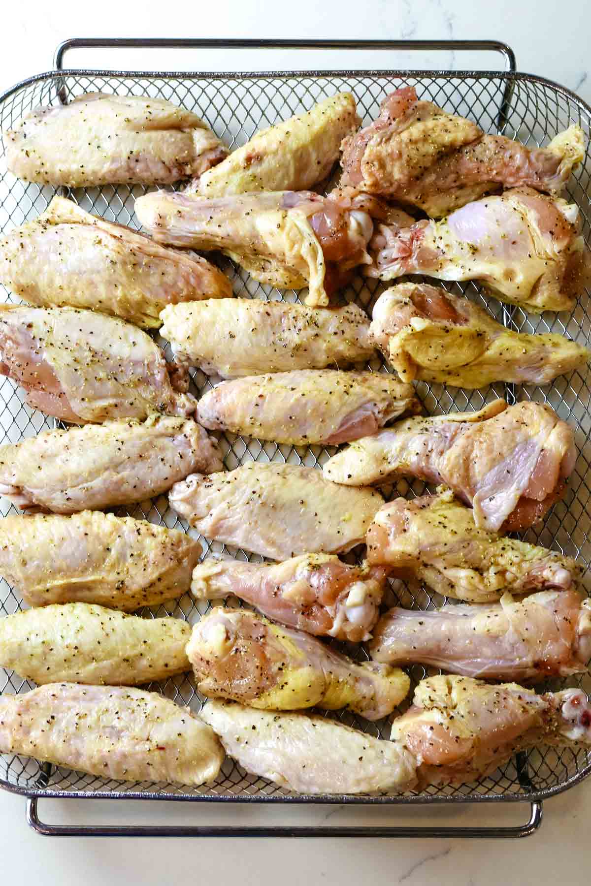 chicken wings spread out in single layer on crisper tray.