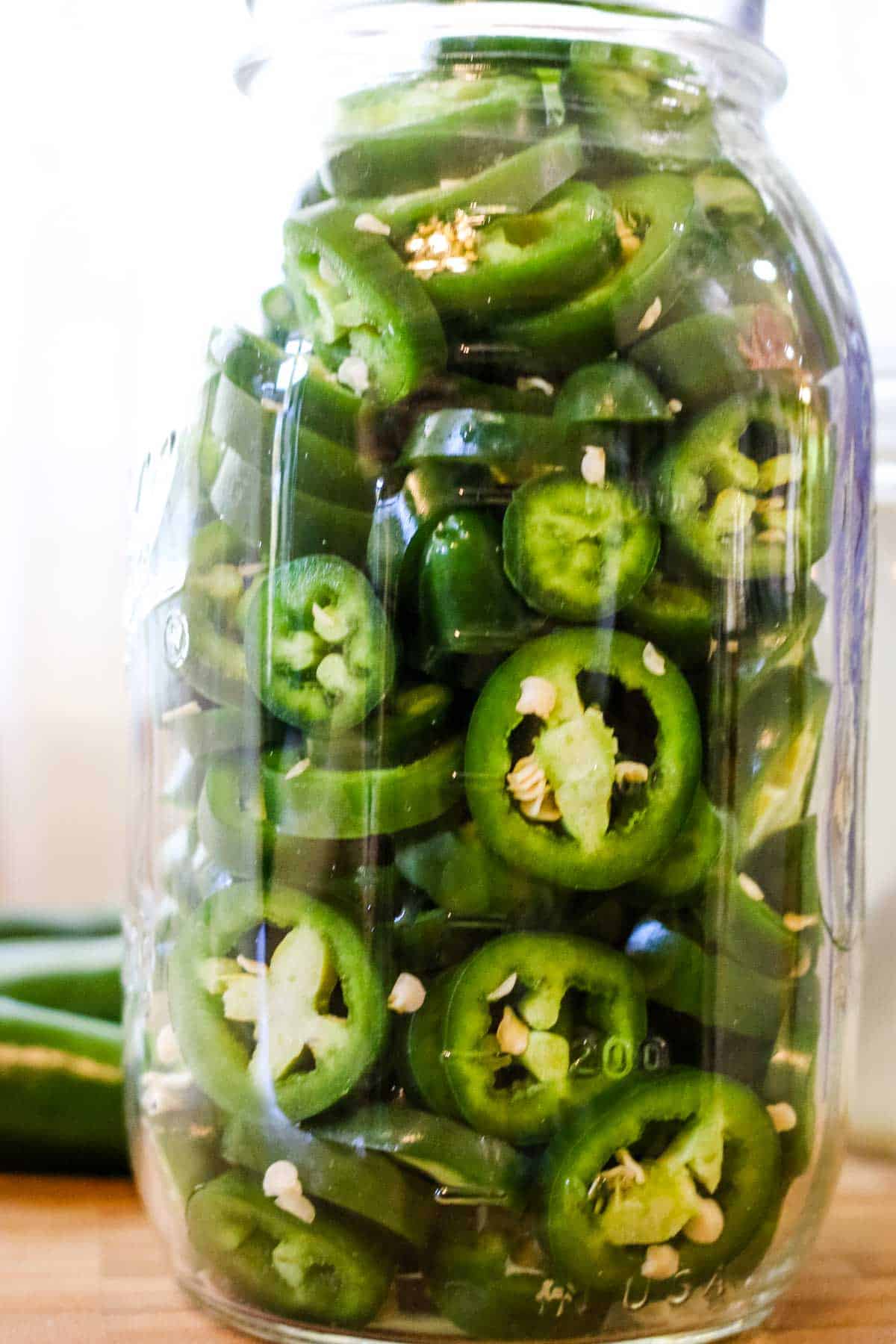 sliced jalapenos in a mason jar.