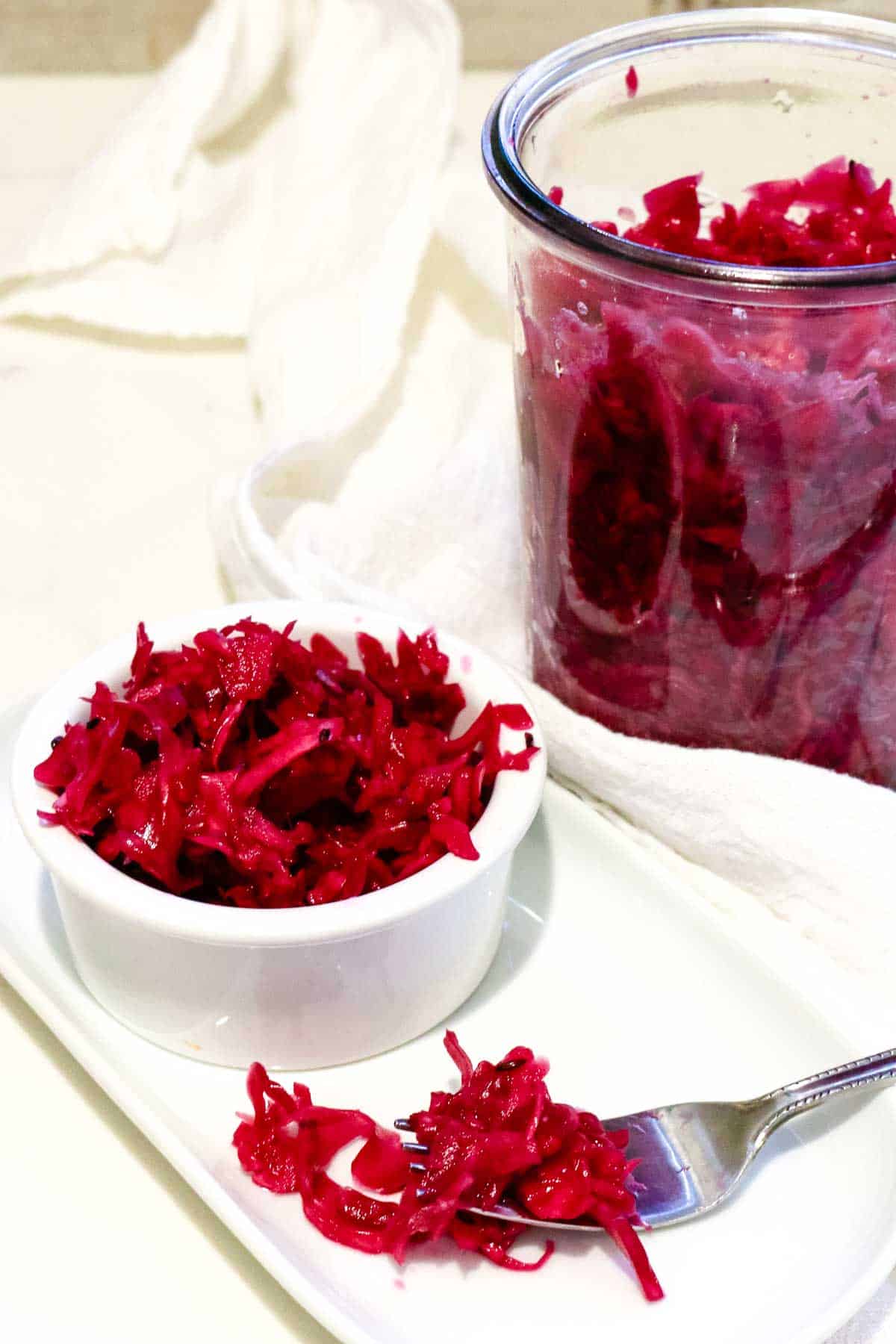 Fermented Red Cabbage sauerkraut recipe in a small ramekin and jar.