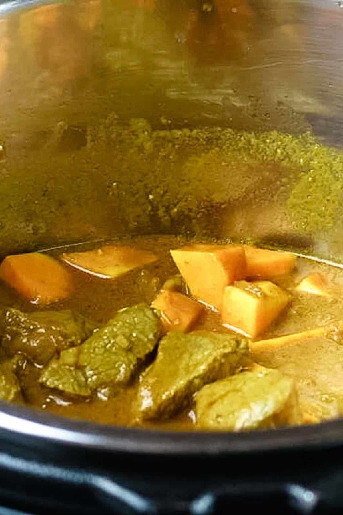 adding squash and seasonings to instant pot curry.