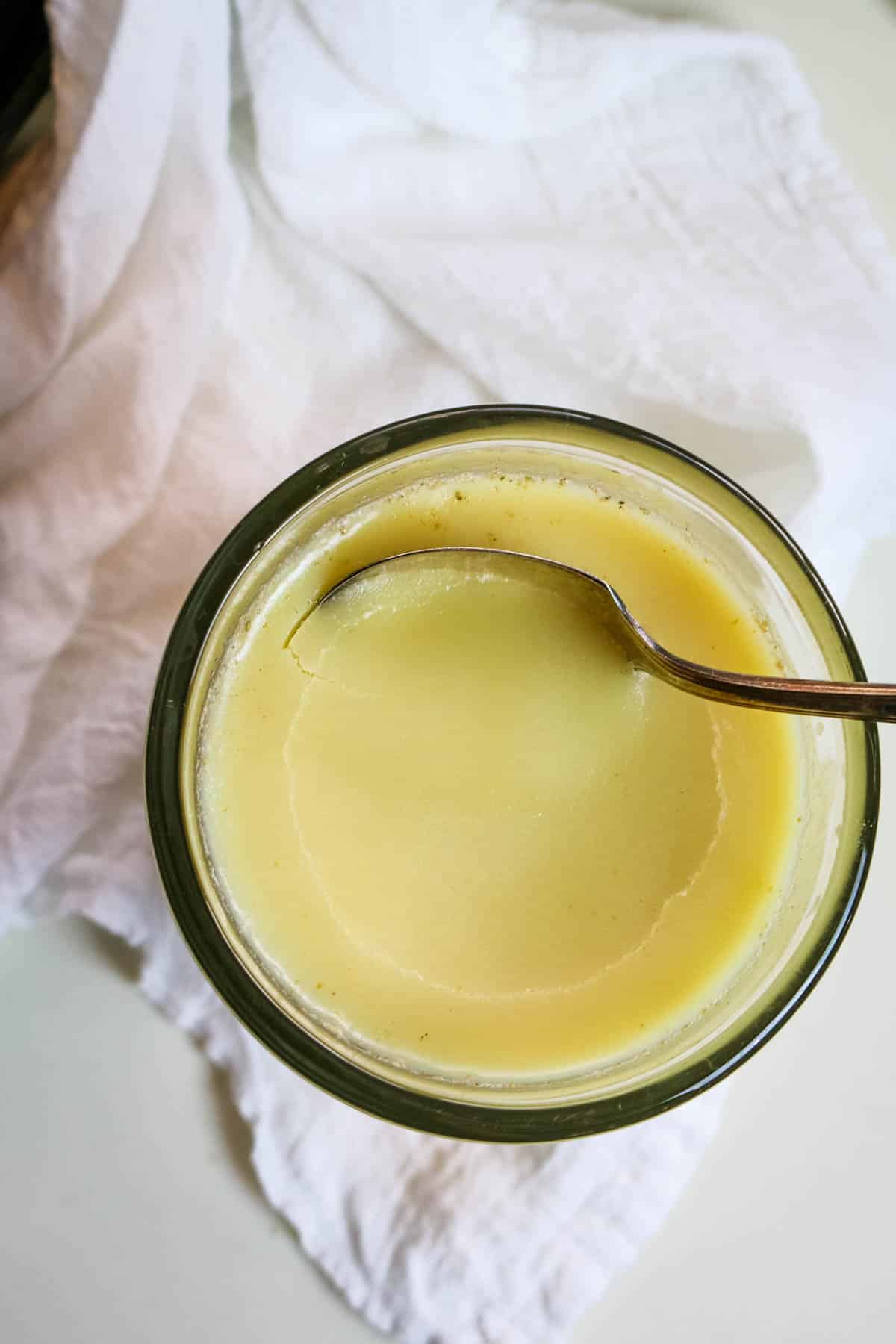 beef tallow in a jar with a spoon