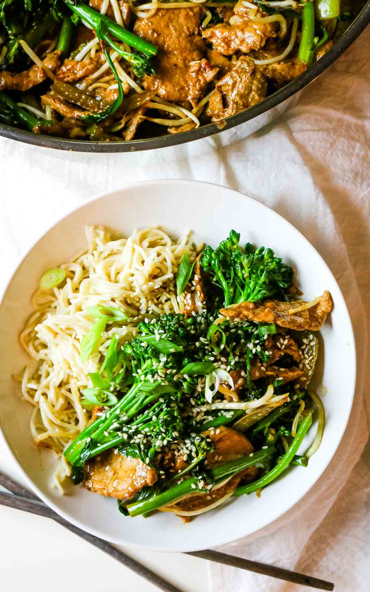 sticky pork with broccoli and ramen on white bowl.