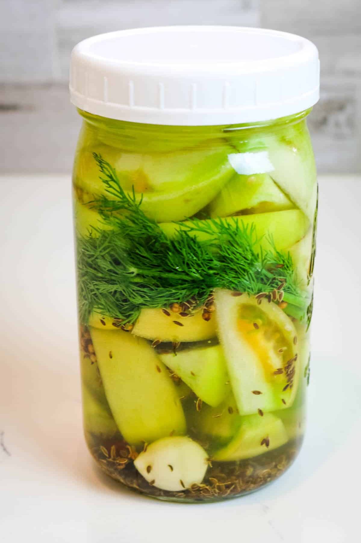 fermented green tomatoes in a jar
