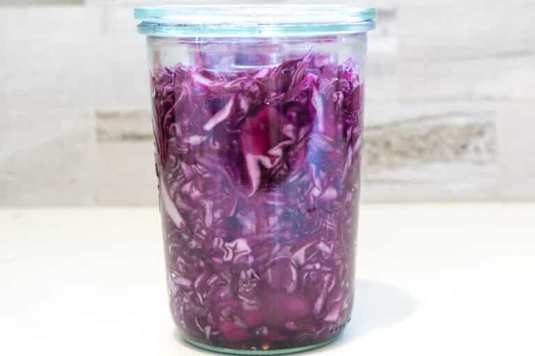 red cabbage fermenting in a glass jar.